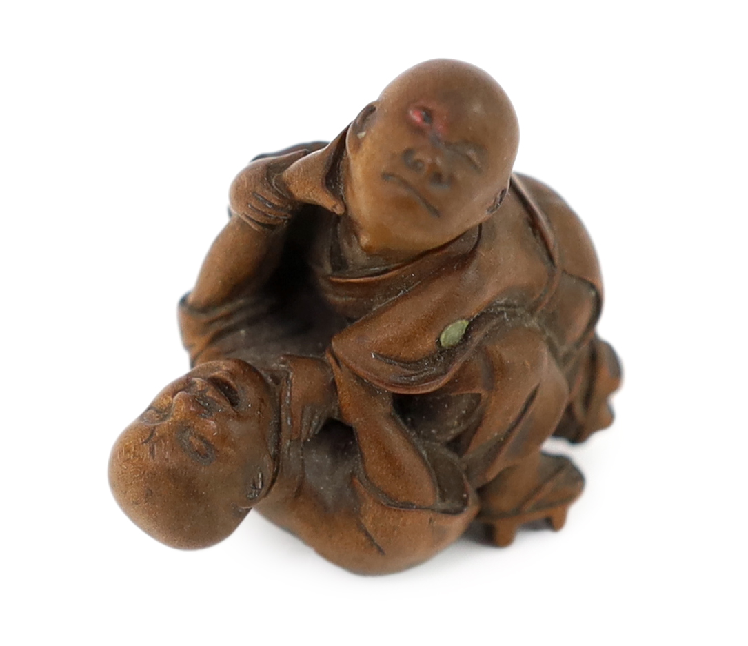 A Tokyo School carved wood netsuke of two boys fighting, 19th century, signed Kakiman